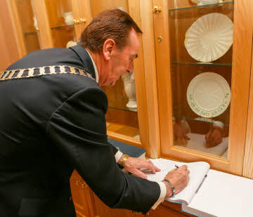 District Governor Jack Cunningham signs the visitors book